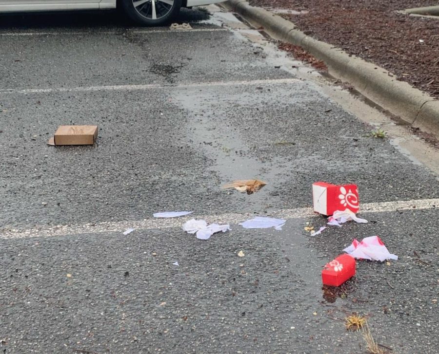 Trash left in the rain in the school parking lot after lunch.