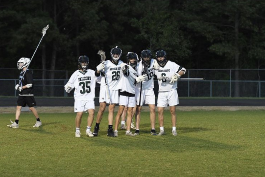 The Men's Lacrosse team shows their spirit and togetherness on the field.