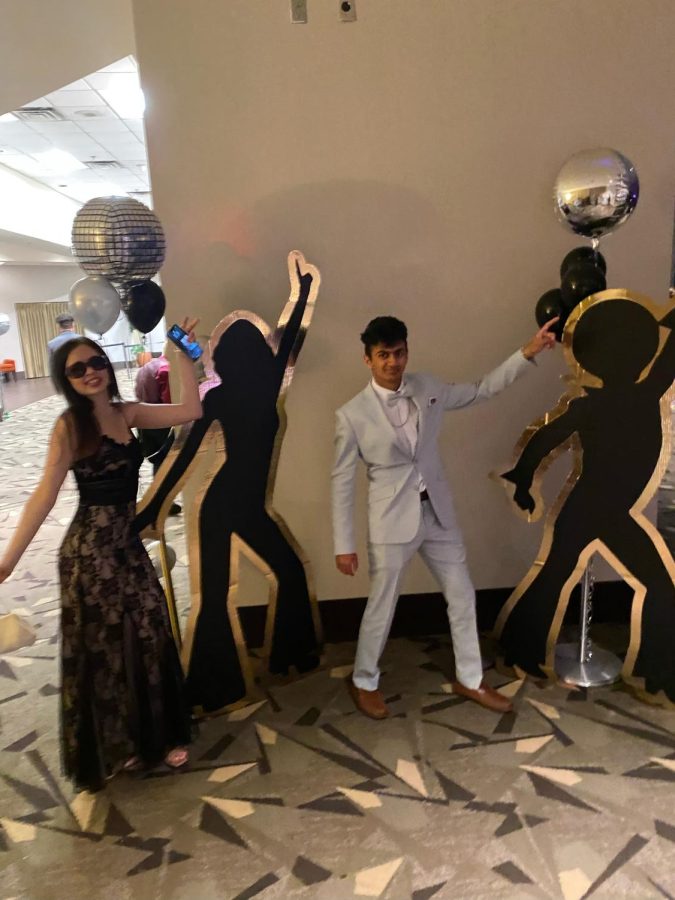 Pictured: Naomi Troiano and Arnav Praveen posing for a photo at prom.