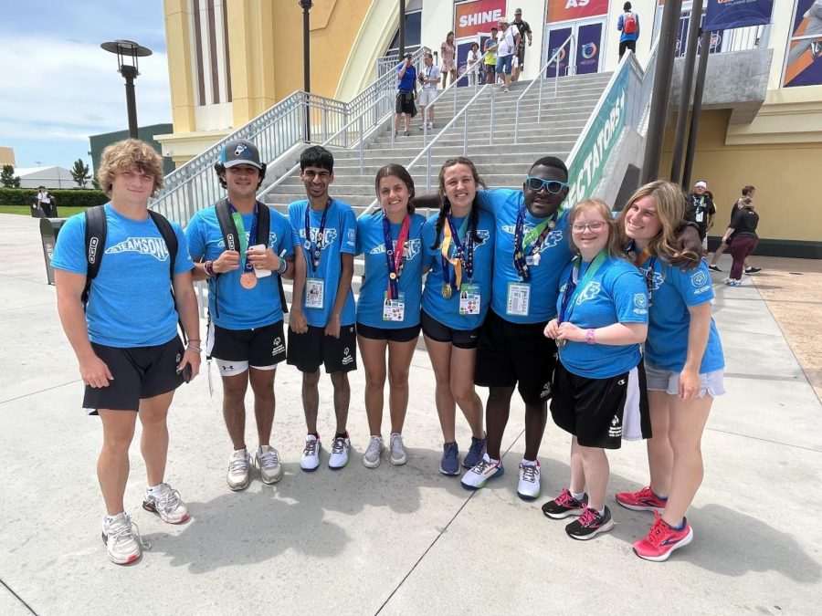 The Unified Track athletes pose outside the ESPN Wide World of Sports complex with their hardware
