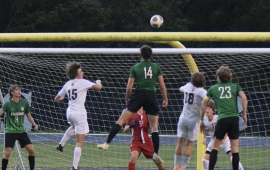 Freshman Adam Granai utilizes his height to head the soccer ball towards the goal.