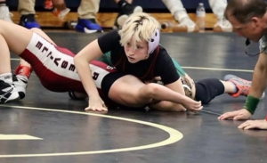 Clara Ealy pins down her opponent in a wrestling match against Rolesville High School during her freshman season.