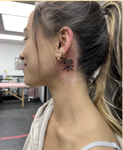 Mia Andreu (23) poses after getting her first tattoo which represents her mothers maiden name. Since Andreu has her dads last name, she wanted her moms apart of her too.