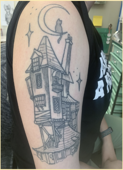 Mrs. Emily Freeman has a full sleeve displaying Harry Potters The Burrow.