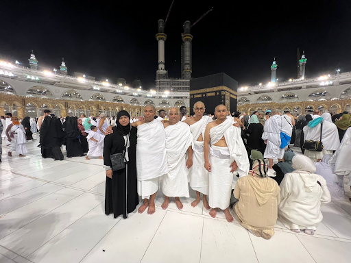 Sohaib and his family at Masjid al Haram after completing Umrah and shaving their heads.