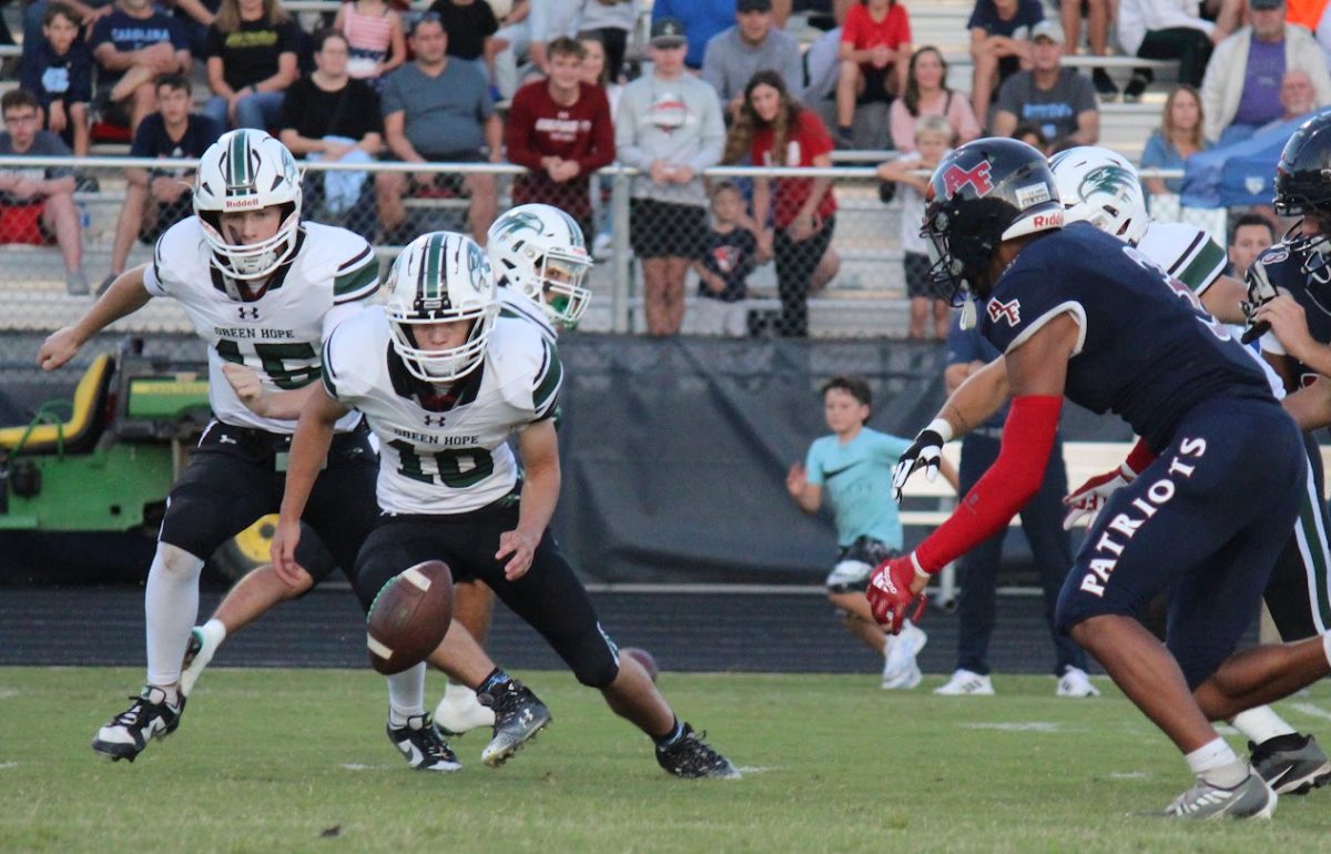 JT (#10) and Jackson (#15) scramble for a ball fumbled on the ground during a game against Apex Friendship.