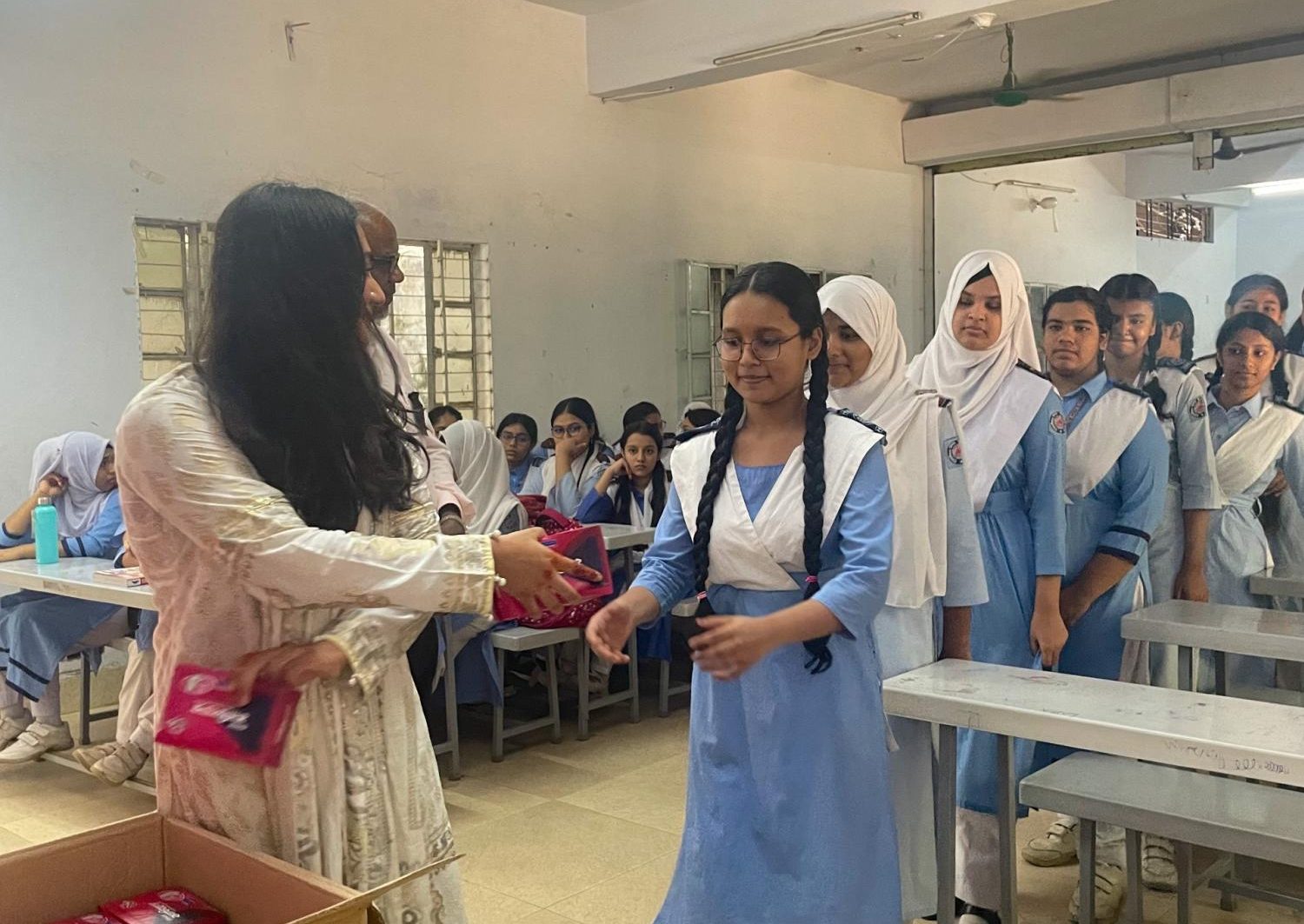 Co-Founder Rose Rosaleen distributes period products for school girls at the Hazaribagh Girls’ Public High School in Dhaka, Bangladesh.