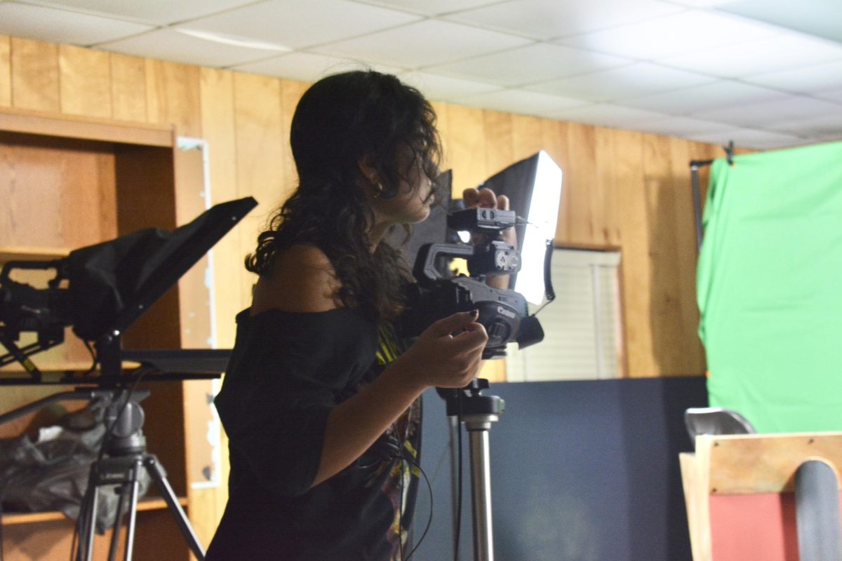 Valentina Garcia helps Mrs. Andrus check on all the cameras again before the production begins.