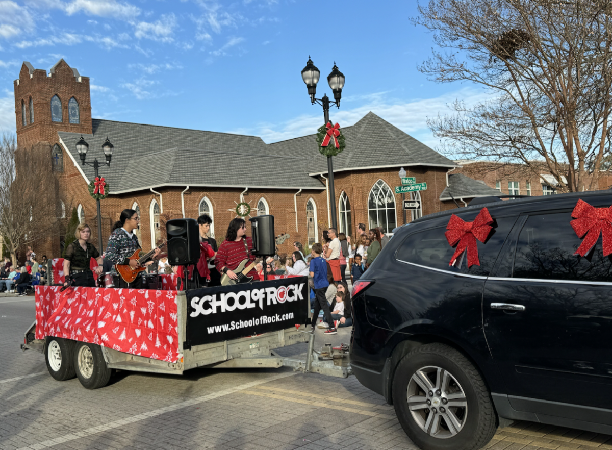 The School of Rock in Cary was the 55th act in line and had a cart with live music as they moved through the streets.