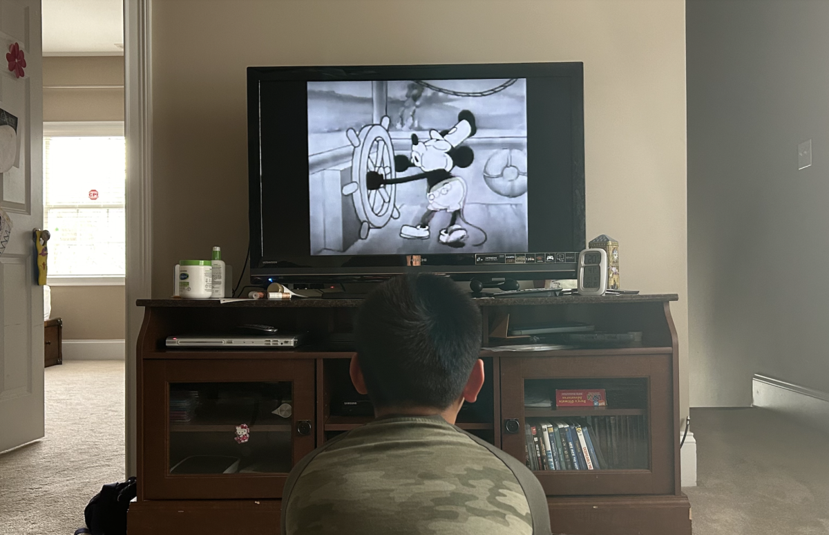 A viewer enjoys a Steamboat Willie animation short, which entered the public domain in 2024. 