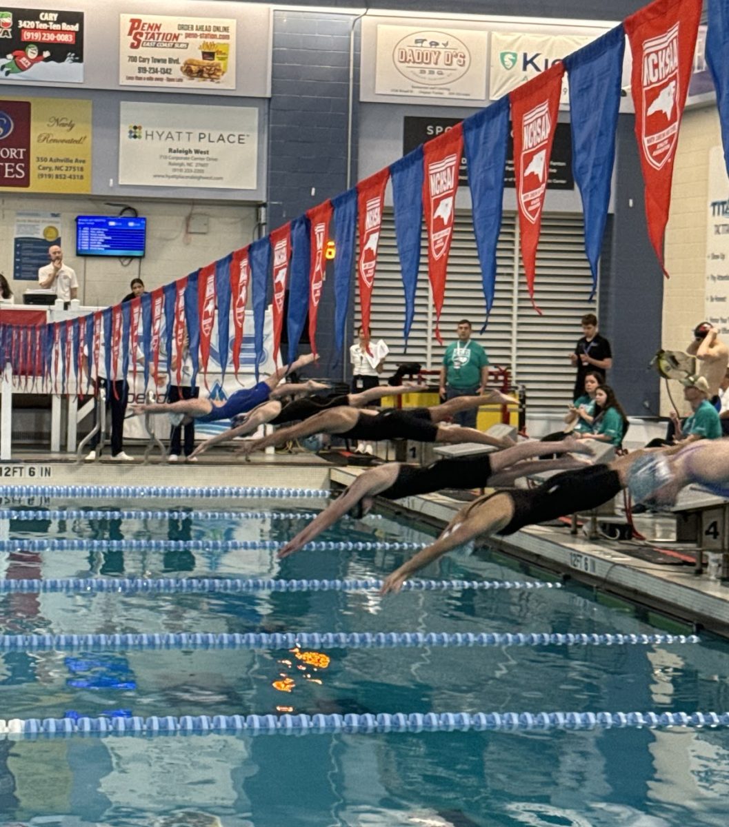 The Green Hope girls diving into a relay during the NCHSAA 4A State Championship Meet, with Green Hope athletes in lane five.
