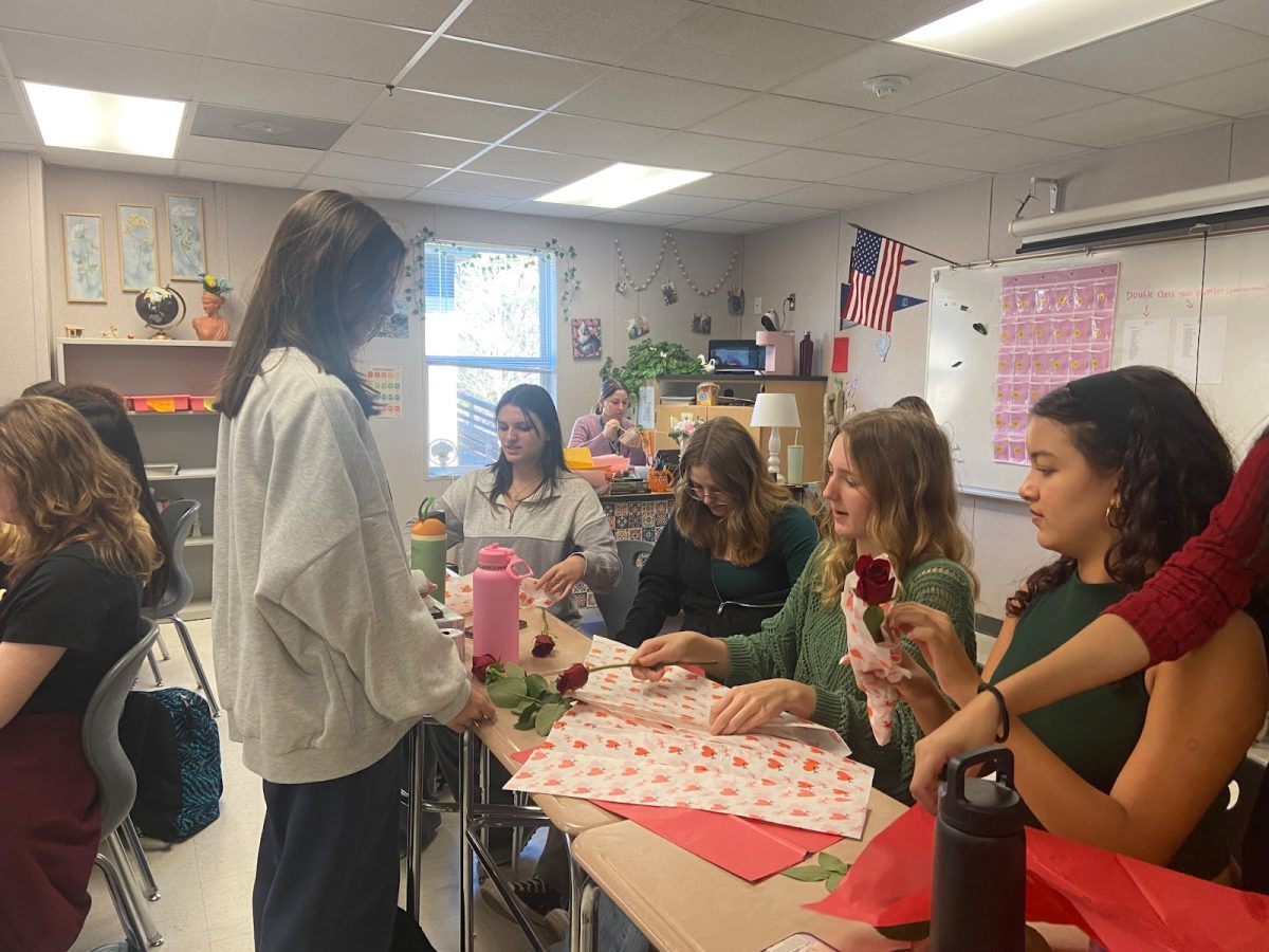 Green Hope womens shelter club members take part in the annual Valentines Day event, wrapping individual roses for the Raleigh Womens Shelter.
