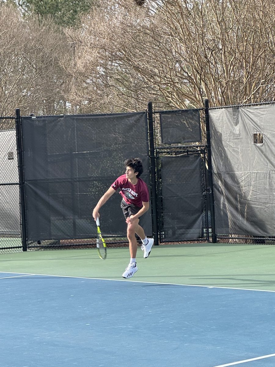 Captain Brij Bhatt (‘25) serves during a home match at Cary Tennis Park. Bhatt has a record of 51-9 for his career. Photo used with permission from Vivek Indlamuri (‘25).

