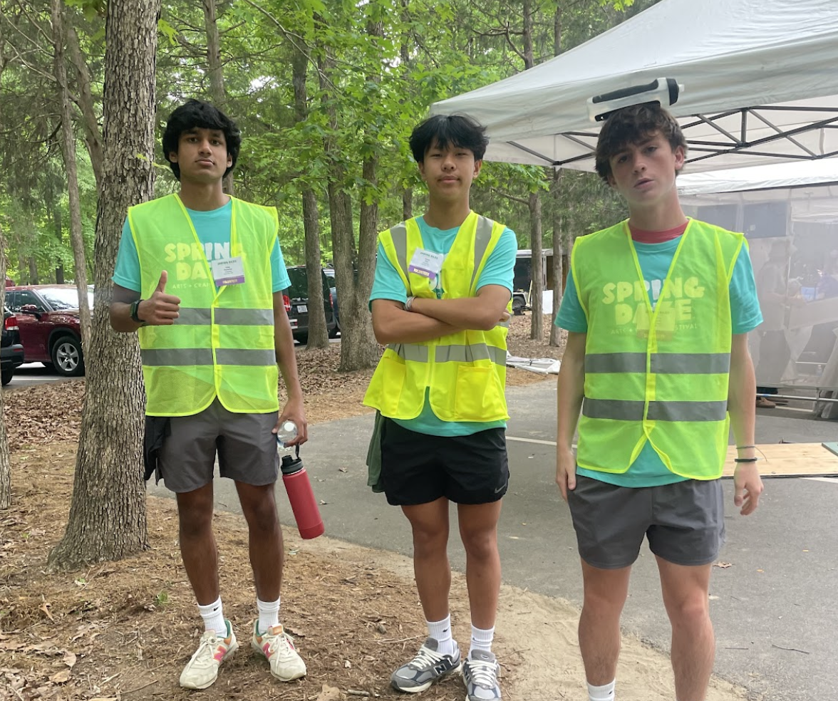 Uday Parashar (‘25), Caleb Kim (‘25) and Andrew Zagacki (‘25) pose for a picture during their evening volunteering shift at the  Spring Daze Festival. Photo used with permission from Rithu Tumkur.