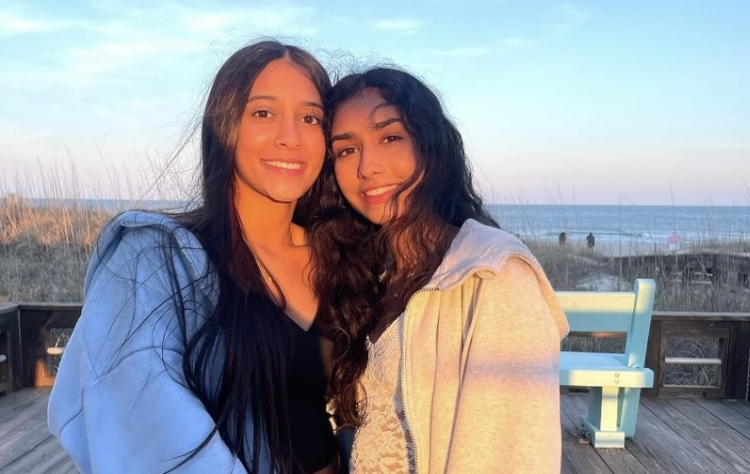 Vibha Kestur (‘24) and Rithu Tumkur (‘25) posing for a picture at Kure beach, while watching the sunset behind them.  Photo used with permission from Avani Purushotham.