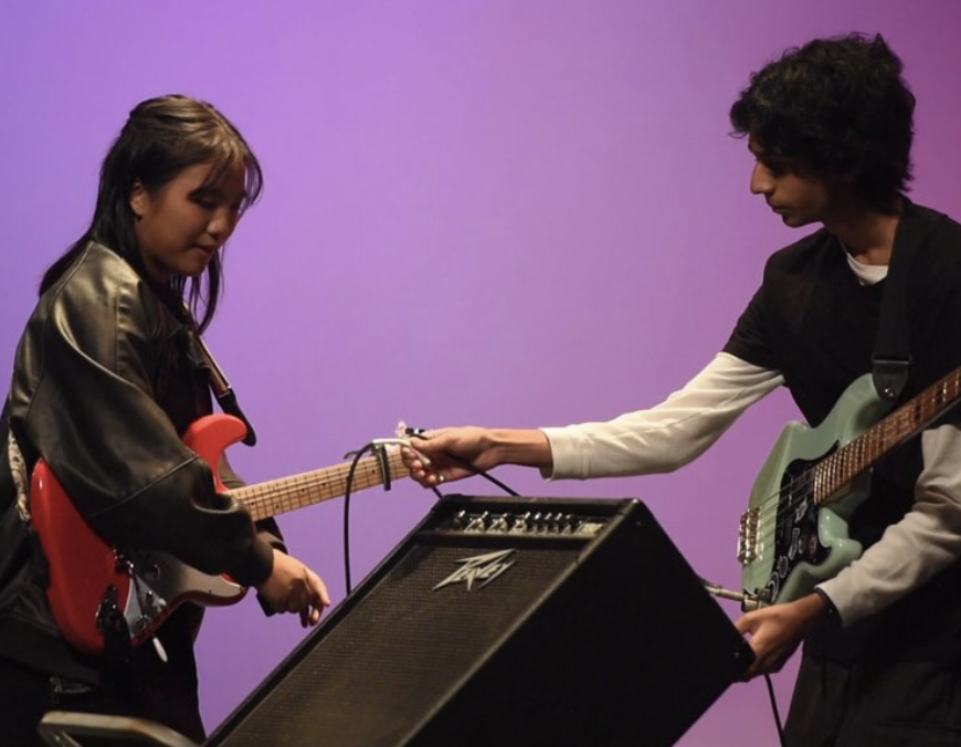 Beginner guitarist Caitlin Belingon (‘25) and bassist Aarush Damarla (‘26) plug their instruments into an amplifier in preparation for their performance at Green Hope’s 2024 Talent Show. Photo used with permission from Caitlin Belingon (‘25).