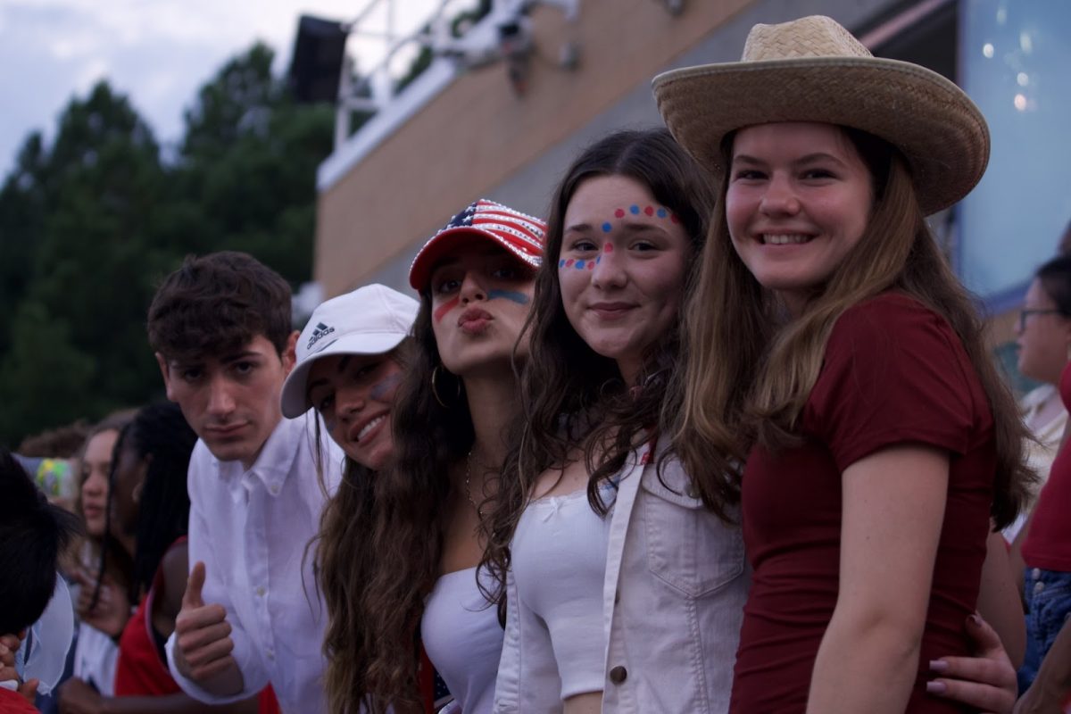 New exchange student Alvise Farinati (‘26) on the left enjoys the Friday night lights.