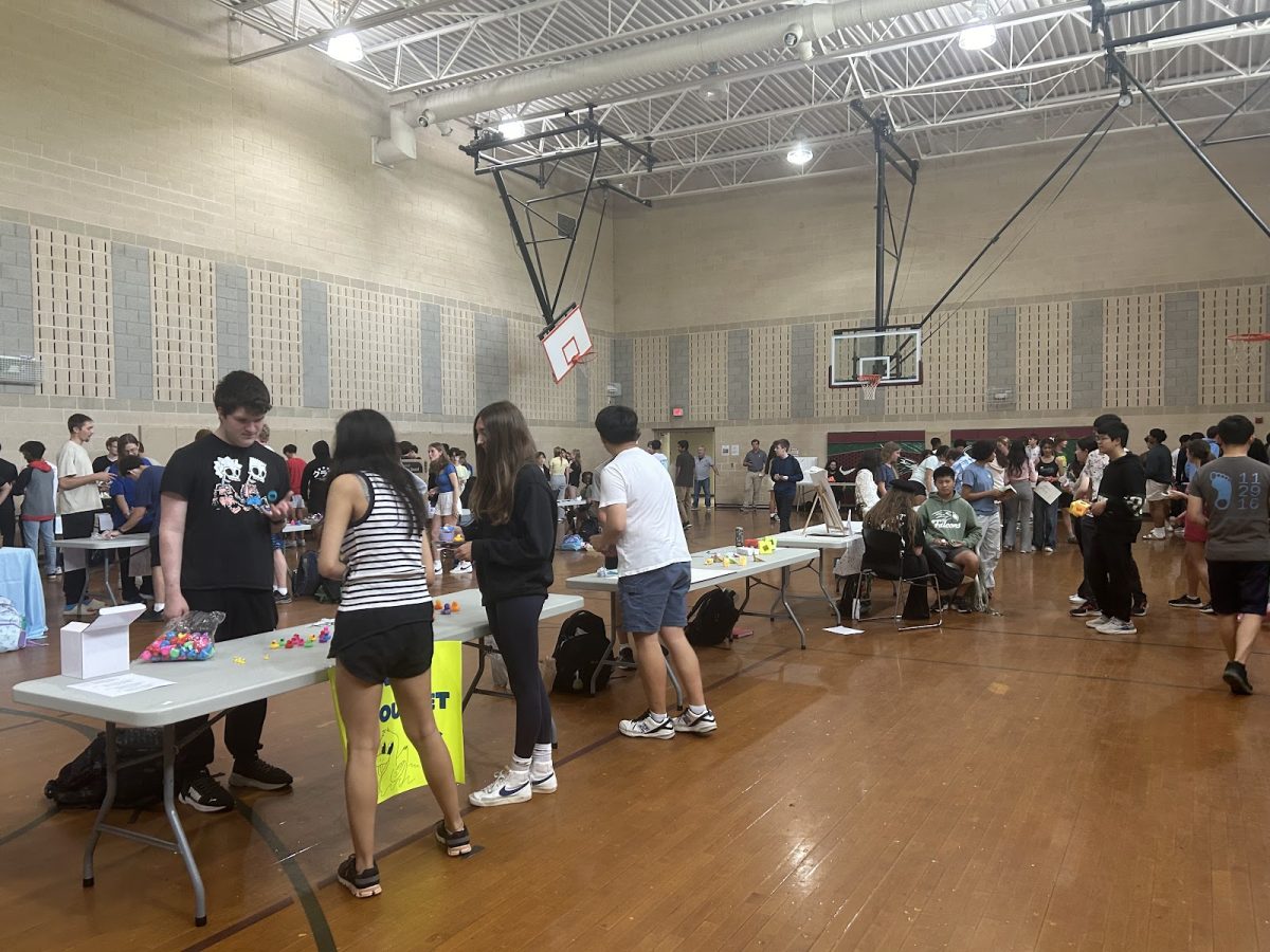 The business fair took place in the aux gym and groups were set up on folding tables they chose. 