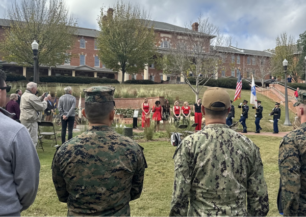 The Ladies in Red and military march being performed in front of NC State soldiers and the community during the ceremony.