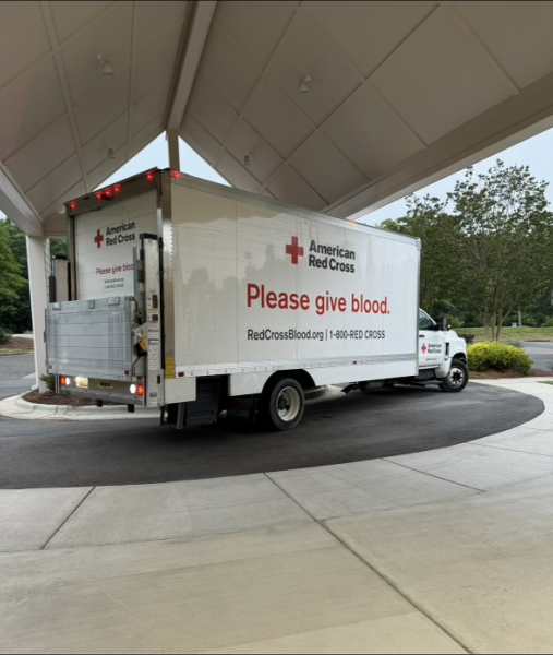 Picture of a Red Cross truck with a sign urging people to give blood.