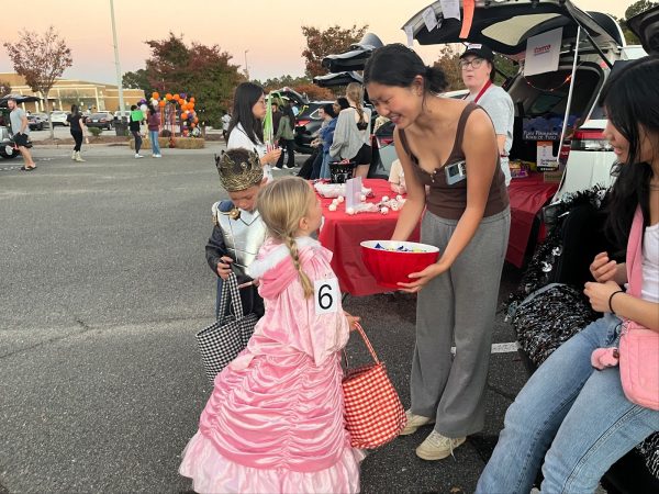 Green Hope High School student volunteers handed out candy at decorated trunks to children who visited them. Photo used with permission from Karuna Shanmugam (‘26).