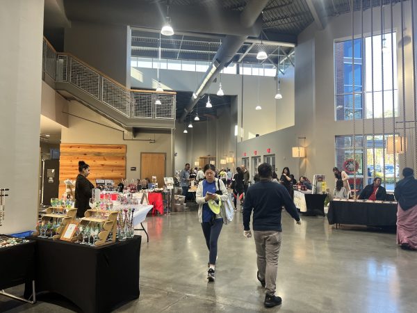 The market showcasing multiple vendor tables and their arts to the visitor inside the Northwest YMCA.
