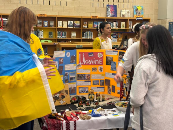 Students learn about Ukrainian culture from a stand at culture night.