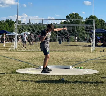 A younger Richards stands ready to throw in a middle school track meet. Photo used with permission from Kyle Richards.