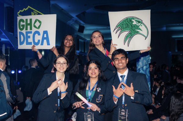 Green Hope DECA members holding up signs before the awards ceremony. Photo used with permission from Jay Kalidindi. 