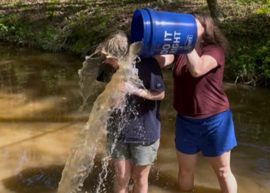 Bratcher stands in the middle of a torrent stream of wetland water, completing the USC MIND challenge. Photo used with permission from Elliot Bratcher.