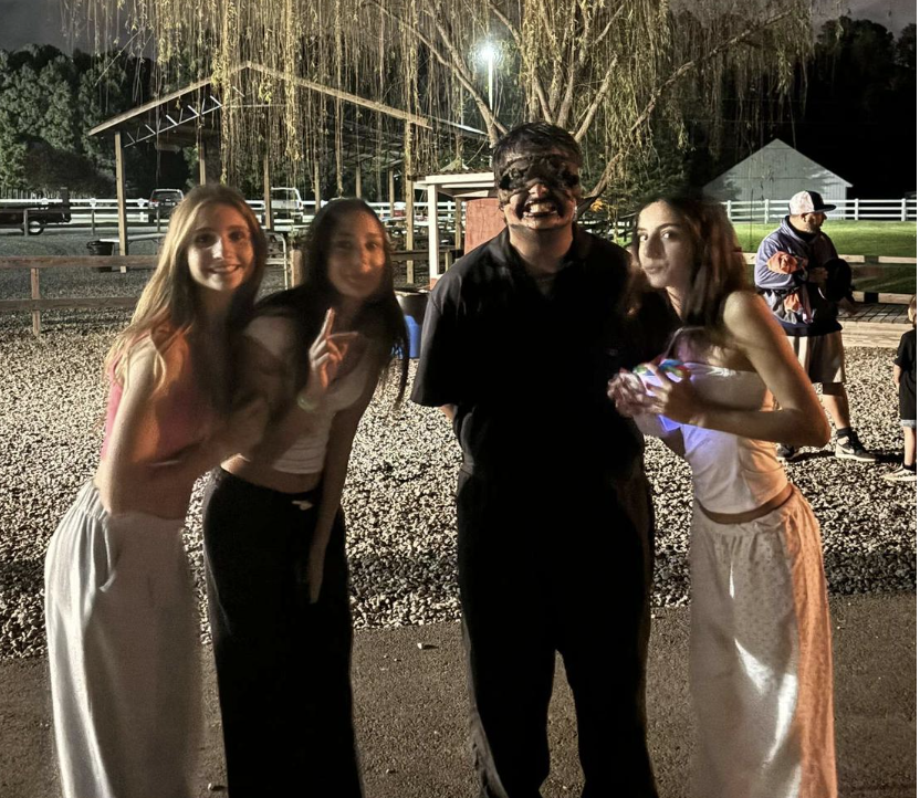 From left to right Ayla Benn (‘28) Sophie Elrihany (‘28) and Bella Sosa (‘28) taking a picture with one of the characters during horror nights. Used with permission from Sophie Elrihany.