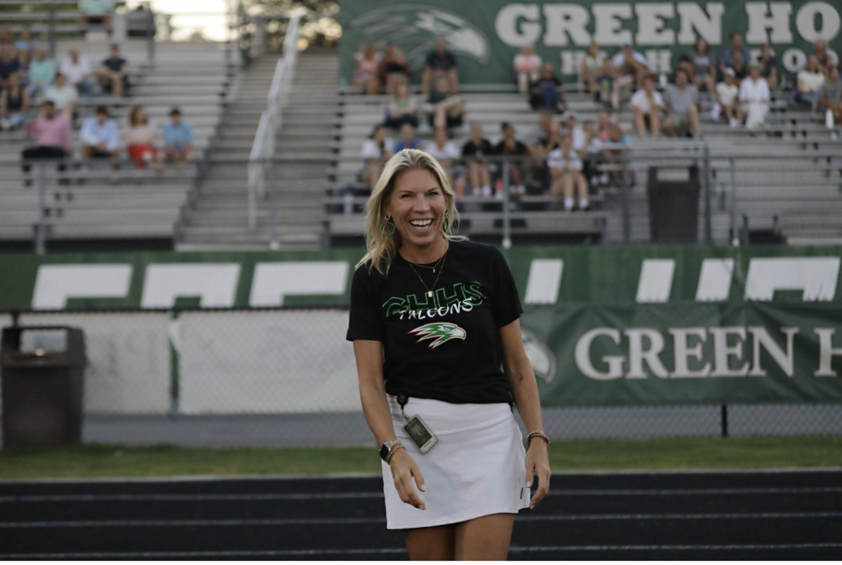 Ms. Cleveland smiling at a Green Hope sporting event. 