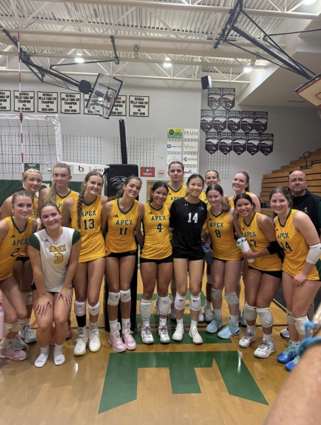 Sherry Wang ‘28 (middle) in black stands with the Apex varsity volleyball team to honor her sportsmanship from 8/28.