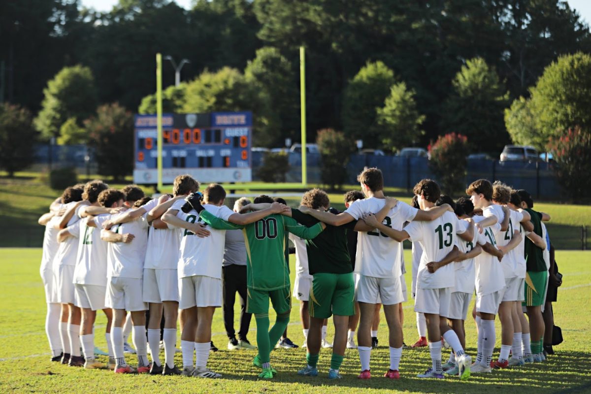 The Falcons come together in a pre-game huddle before going up against the Athens Drive Jaguars. 
