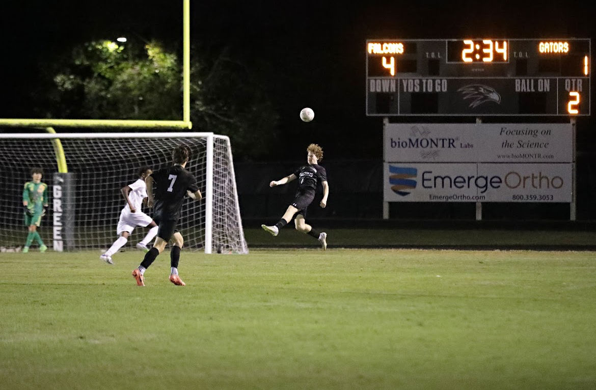 Green Hope controls the ball on their side of the field, mounting an attack on Green Level's defense.