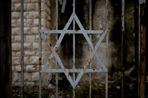 Star of David sits rusting outside of an abandoned synagogue. Photo used with permission from Levi Meir Clancy via Unsplash.
