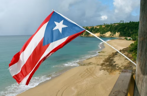 The flag of Bad Bunny's homeland, Puerto Rico, waving in the wind. Photo used with permission from Ana Toledo via Unsplash.