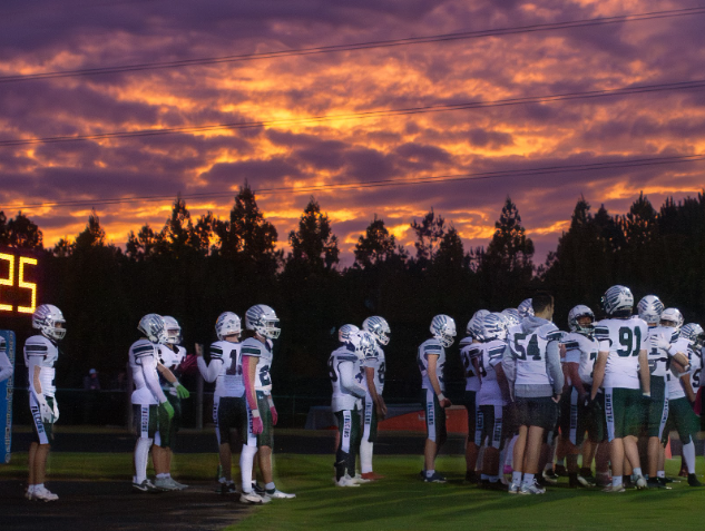 The Green Hope football team warms up, getting ready to play. Photo used with permission from Sameer Daswani.