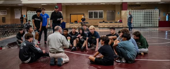 Coach Sodano talks to the team at the Wolverine Challenge at Wakefield High School. Photo used with permission from @greenhope_wrestling via Instagram.