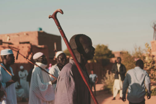A Sudanese man holding his cane. Photo used with permission from Yusuf Yassir on Unsplash.