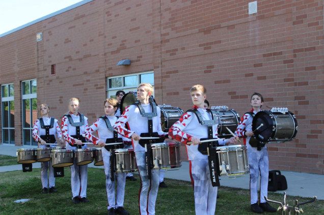 Green Hope Indoor Percussion members pose for media day, holding their respective instruments. Photo used with permission from Pierce Holbrook.