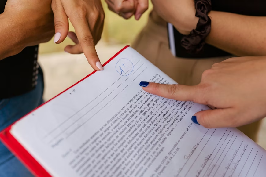 Students observe a high grade given on an assignment. Such academic pressure and comparison can take a toll on one’s mental health. Photo used with permission by Andy Quezada via Unsplash.