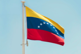 The Venezuelan flag, flying high in the midst of recent controversy and events. Photo used with permission from Aboodi Vesakaran on Unsplash.