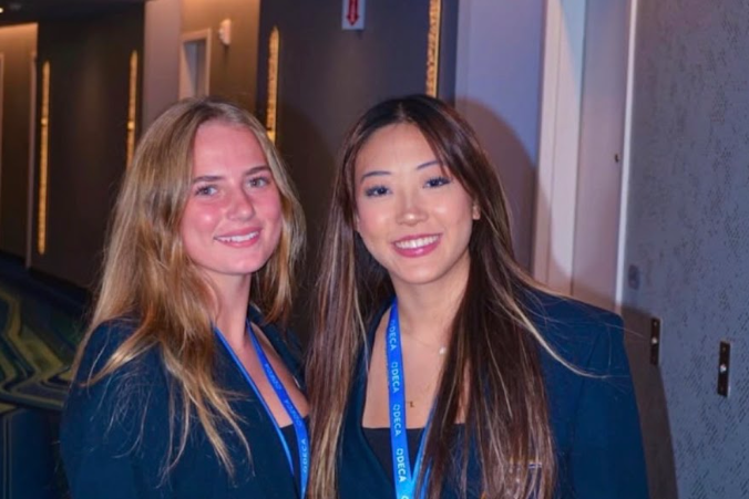 Elizabeth Chen (right) stands with fellow DECA member Ella Chase (left) at the ICDC national competition. Photo used with permission from @greenhopedeca via Instagram.