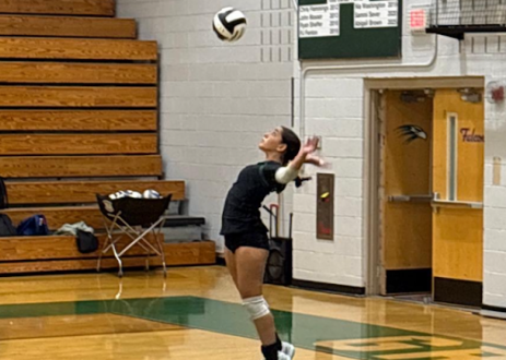 Zoie Fatal jump serves the ball at a Green Hope High School volleyball game. Photo used with credits from Shiri Shalka Cosigny.