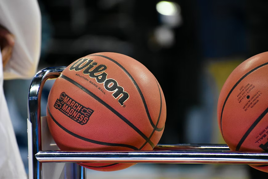 This image features basketballs marked with a special March Madness logo. Photo used with permission from Tod Greene on Unslpash.