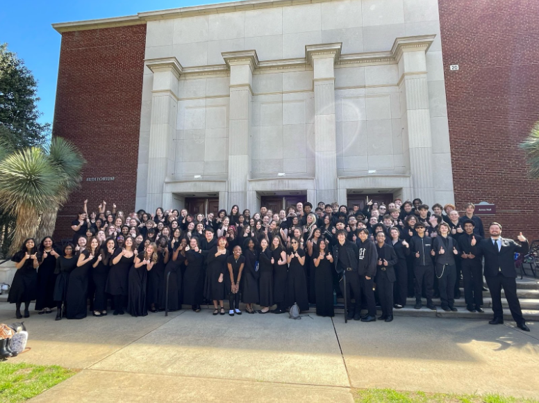 Multiple ensembles of Green Hope's choir pose outside of the performance hall at Meredith College. Photo used with permission from Allen Botwick.