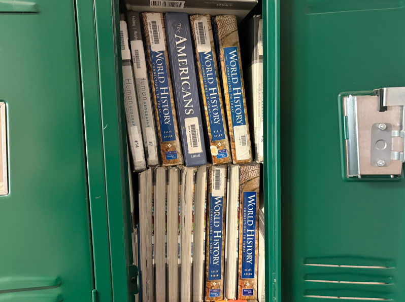 Stacks of outdated textbooks sit inside the Mod-4 lockers at Green Hope after the school moved away from purchasing physical copies in favor of digital resources. 