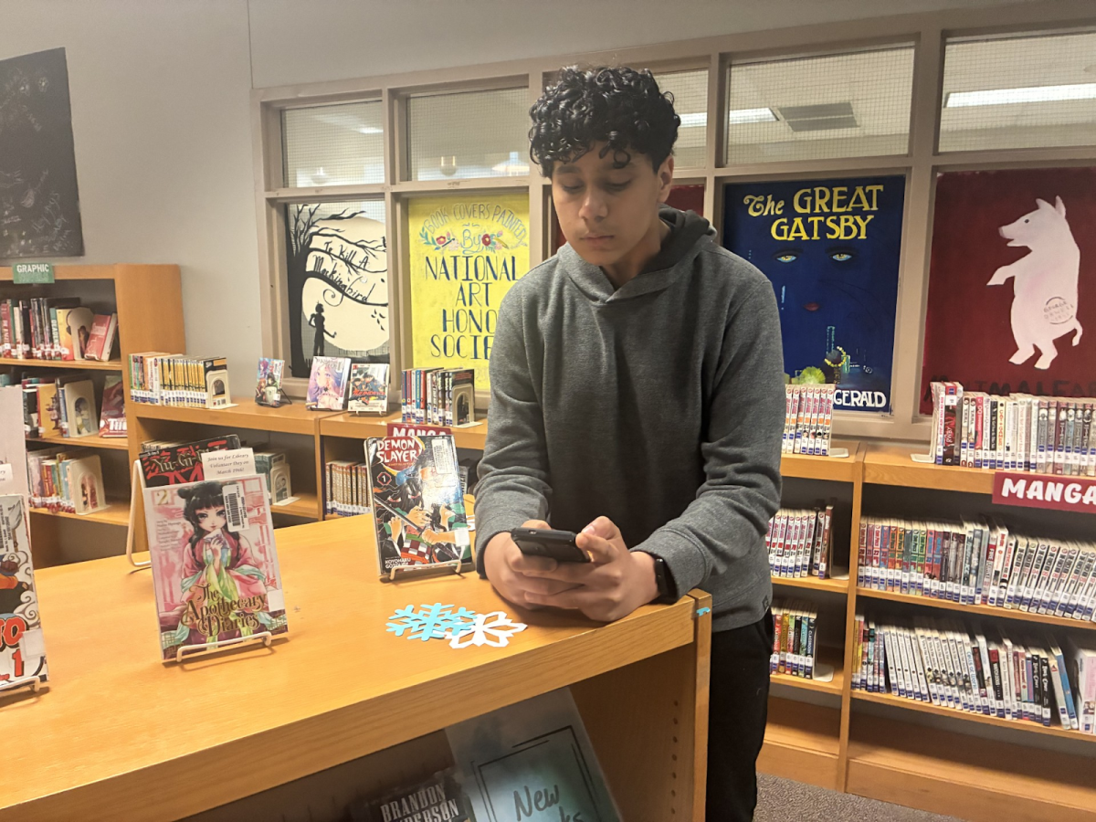 Sahishnu Popuri ('29) watching his phone in the Green Hope library. Students usually use their phones in the library instead of getting academic support.