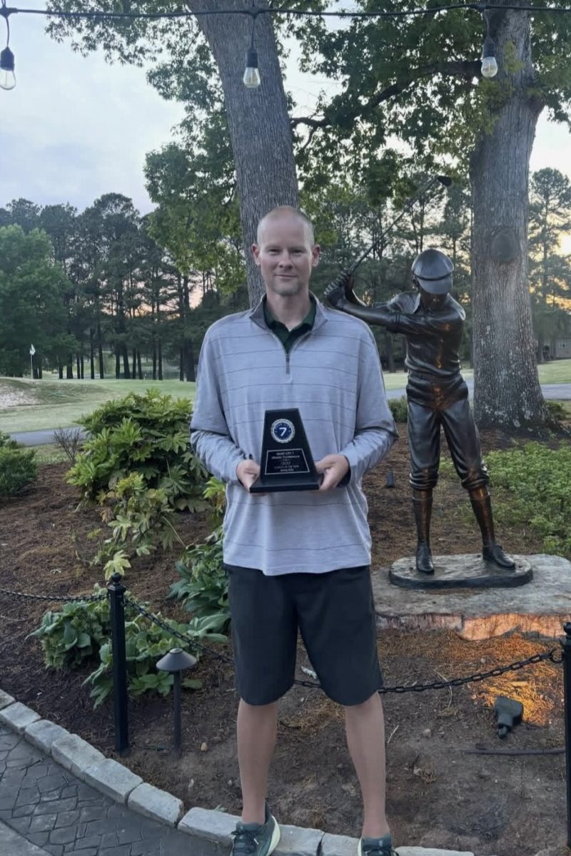 Coach Denton poses with his award following the team's conference championship match. Photo used with permission from @ghhs_mens_golf on Instagram.